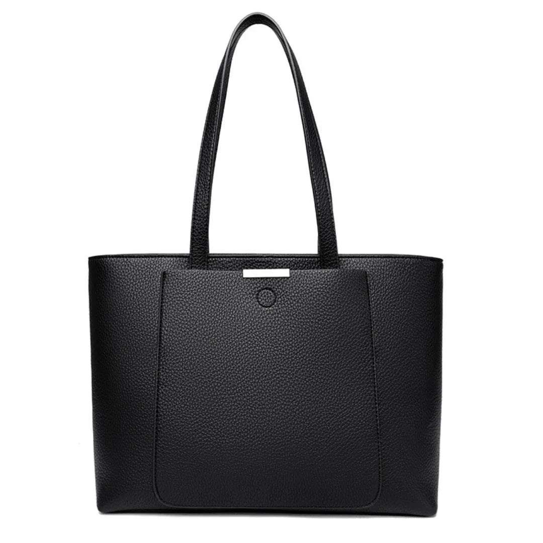 Black leather tote bag with front pocket and dual shoulder straps on a white background