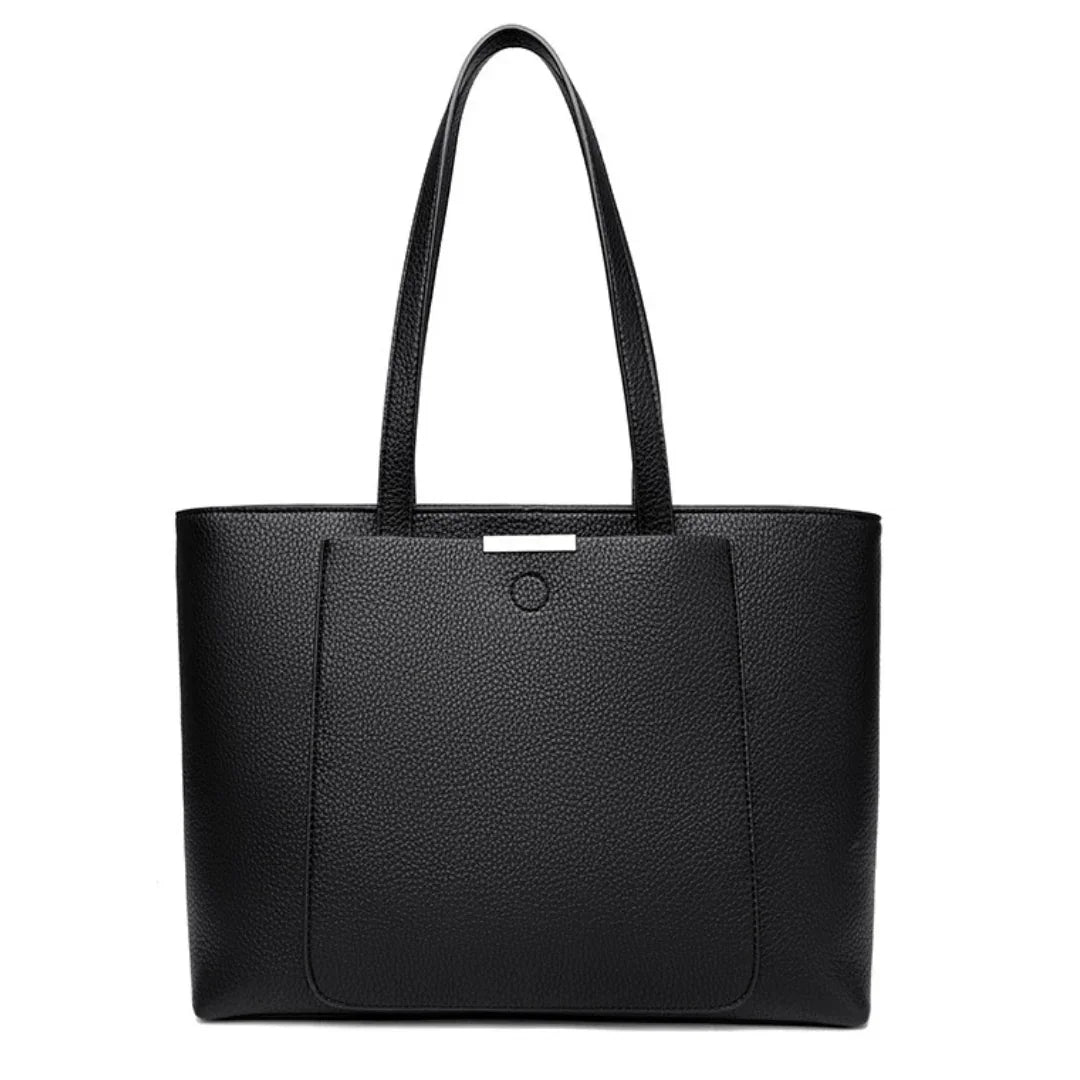 Black leather tote bag with front pocket and dual shoulder straps on a white background