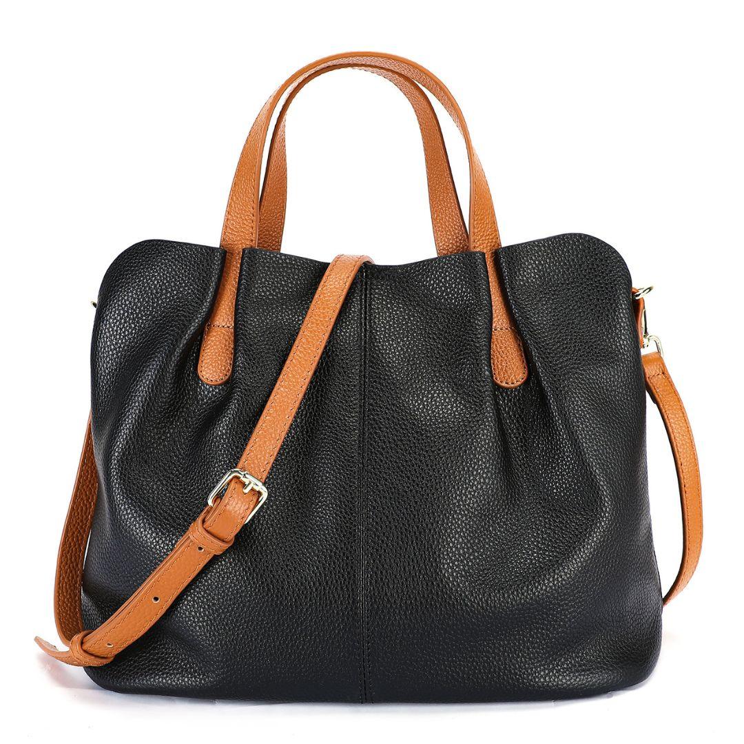 Black leather tote bag with brown handles and adjustable shoulder strap