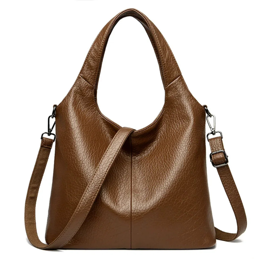 Brown leather tote bag with detachable shoulder strap on white background