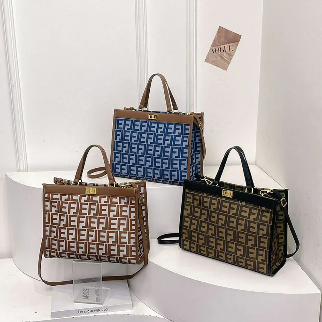 Three designer tote bags with FF monogram pattern in blue, white, and brown on display shelves.