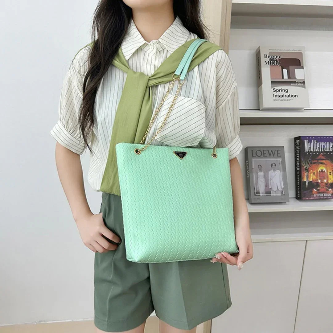 Woman in striped shirt and green shorts carrying mint green tote bag in modern room
