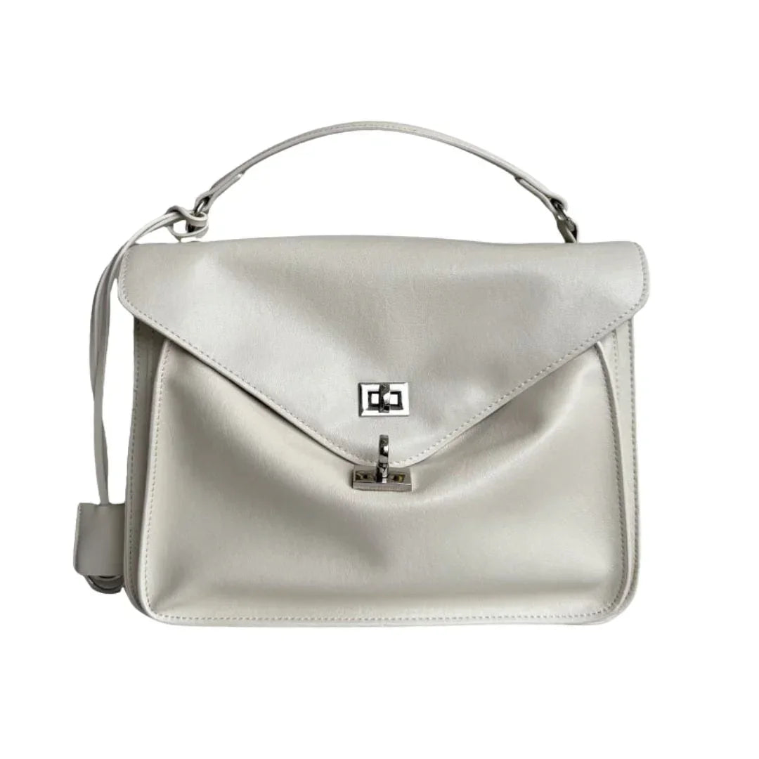 White leather handbag with top handle and silver clasp on white background