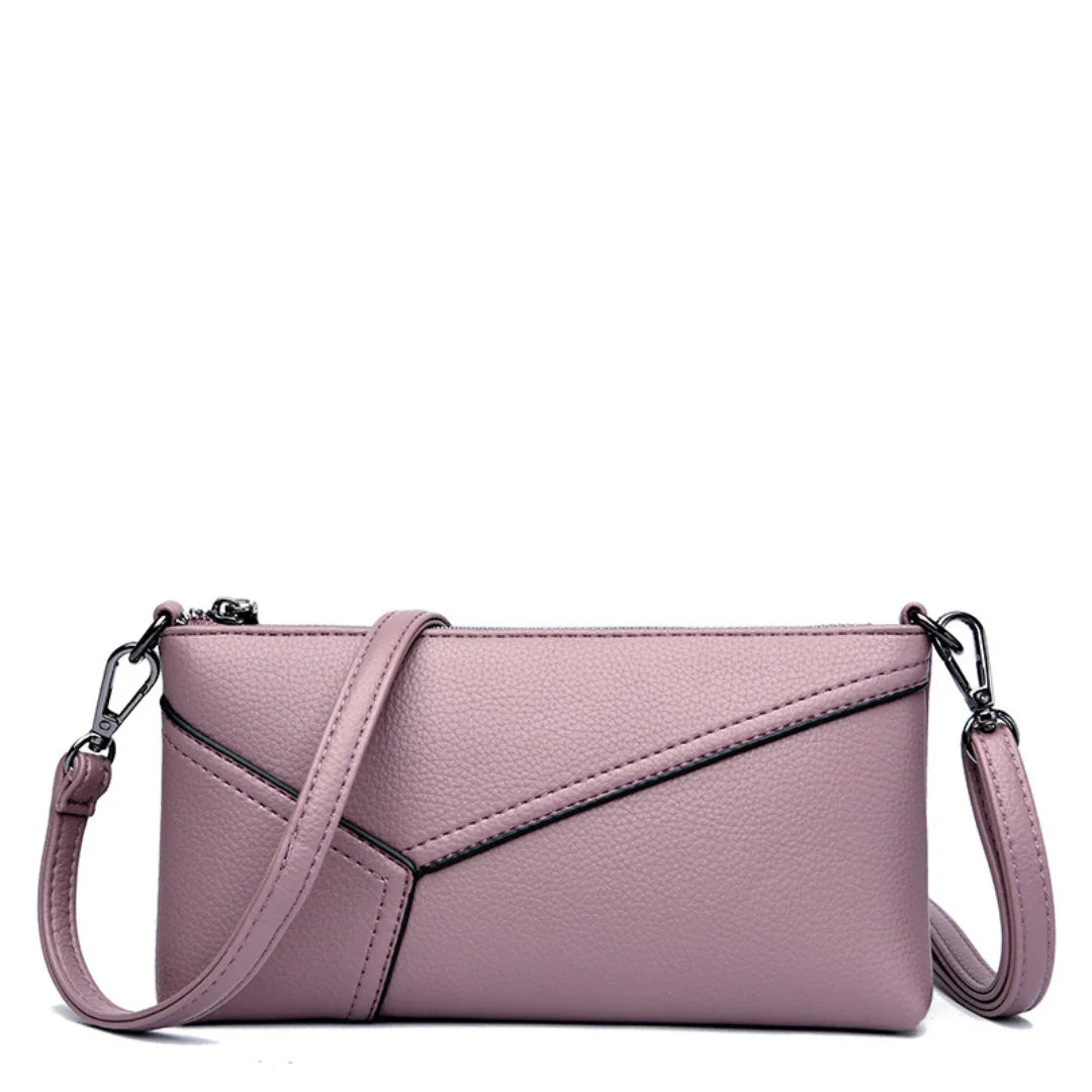 Light purple leather crossbody bag with geometric stitching and detachable strap