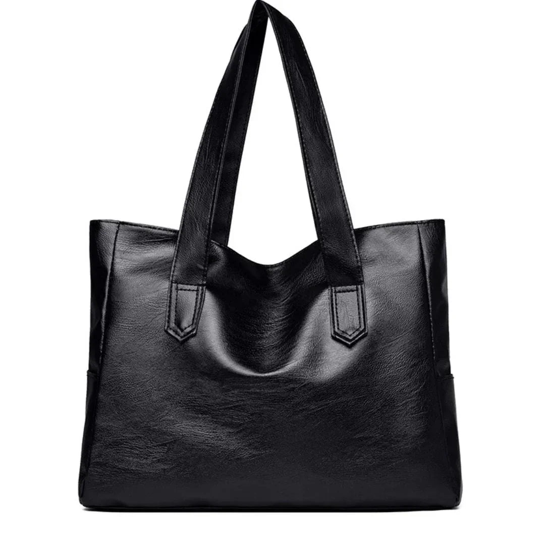 Black leather tote bag with dual handles on white background