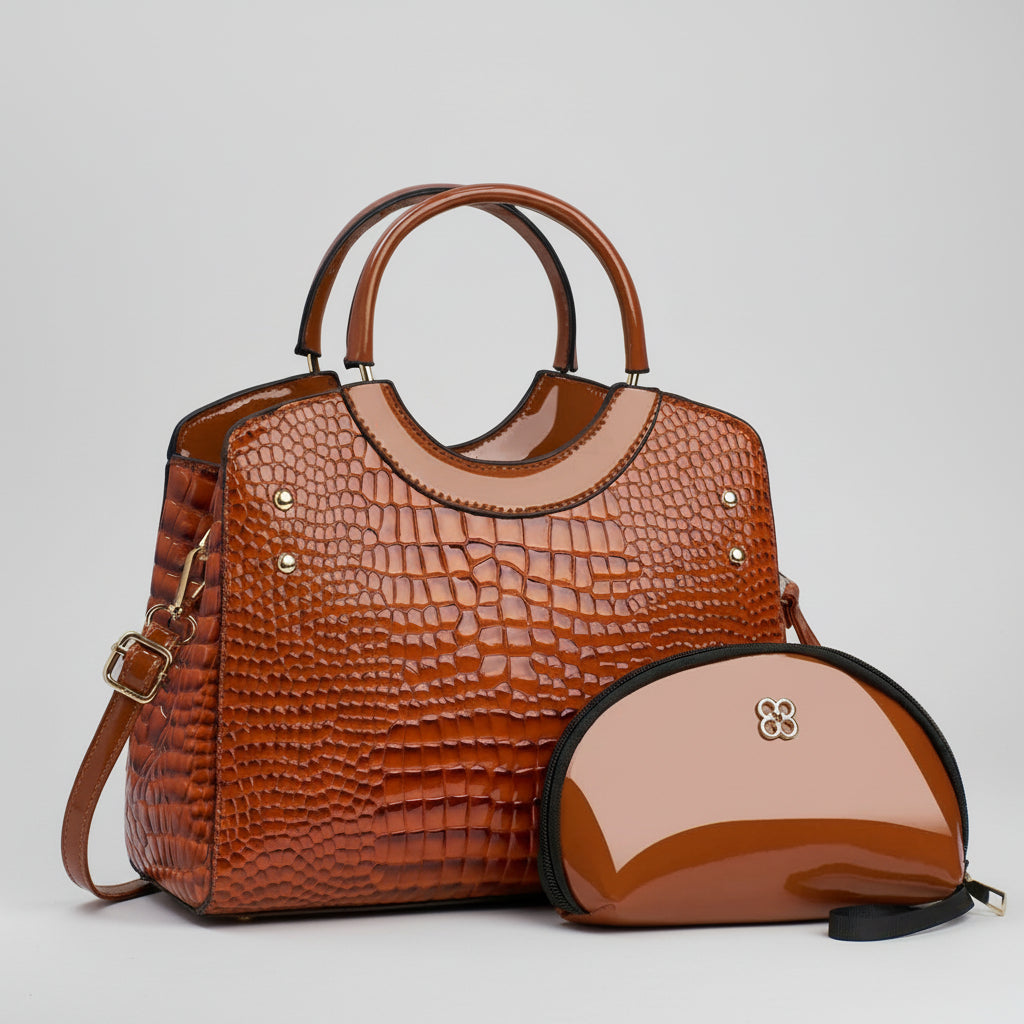 Glossy brown crocodile-pattern handbag with matching cosmetic pouch on white background