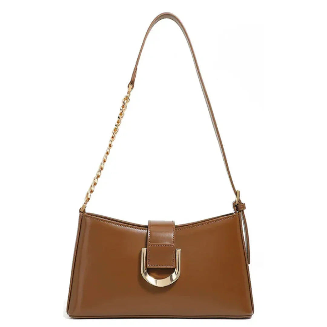 Brown leather shoulder bag with gold chain strap and metallic buckle on white background