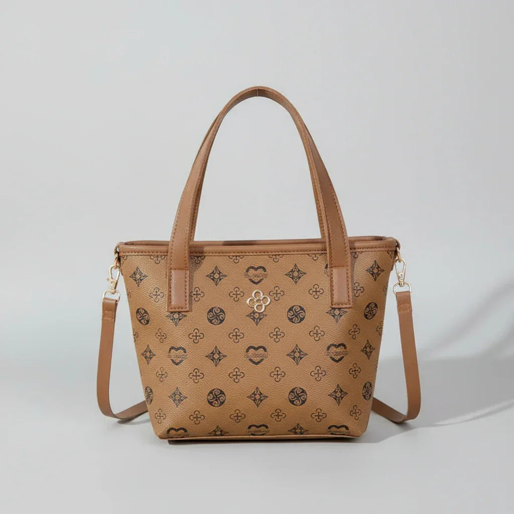 Brown leather patterned tote bag with shoulder strap on a neutral background