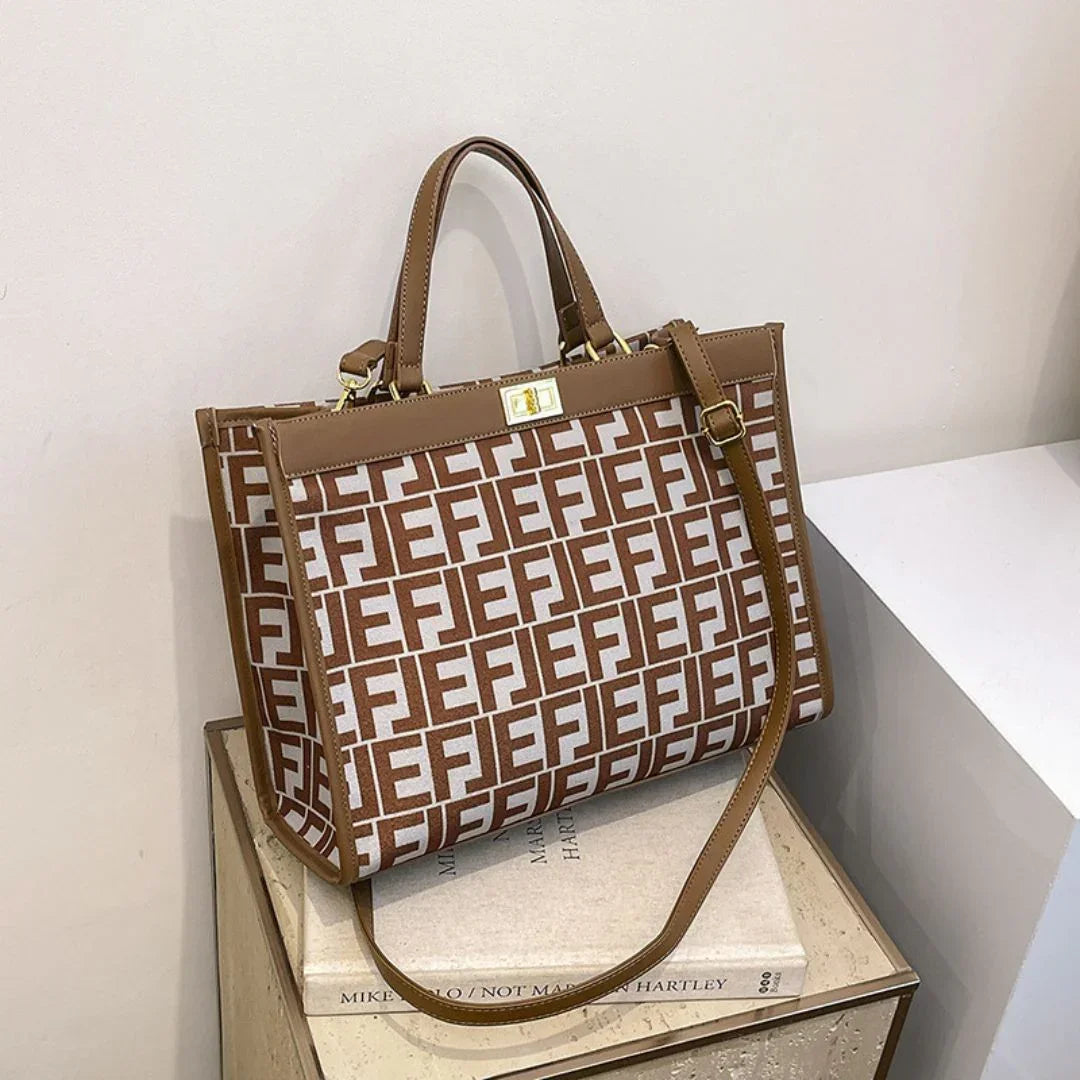 Brown and white tote bag with geometric FE pattern on a beige surface