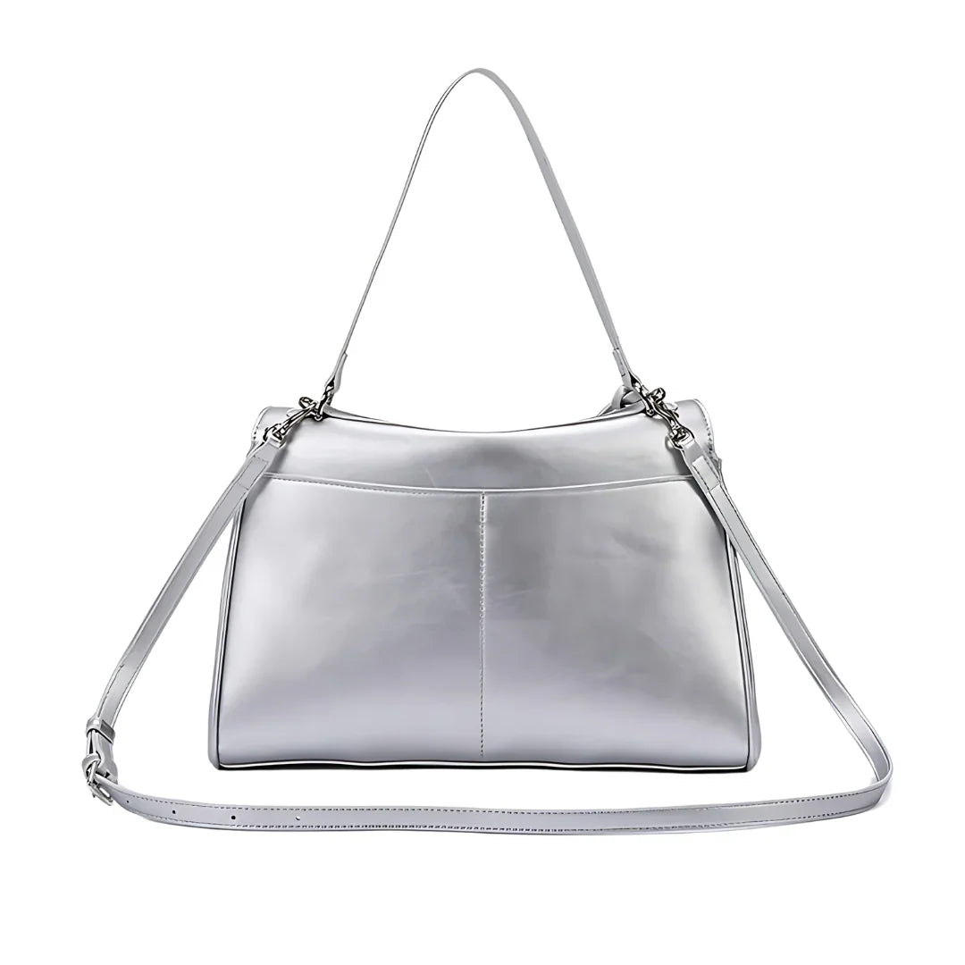 Sleek silver leather shoulder bag with adjustable strap on white background