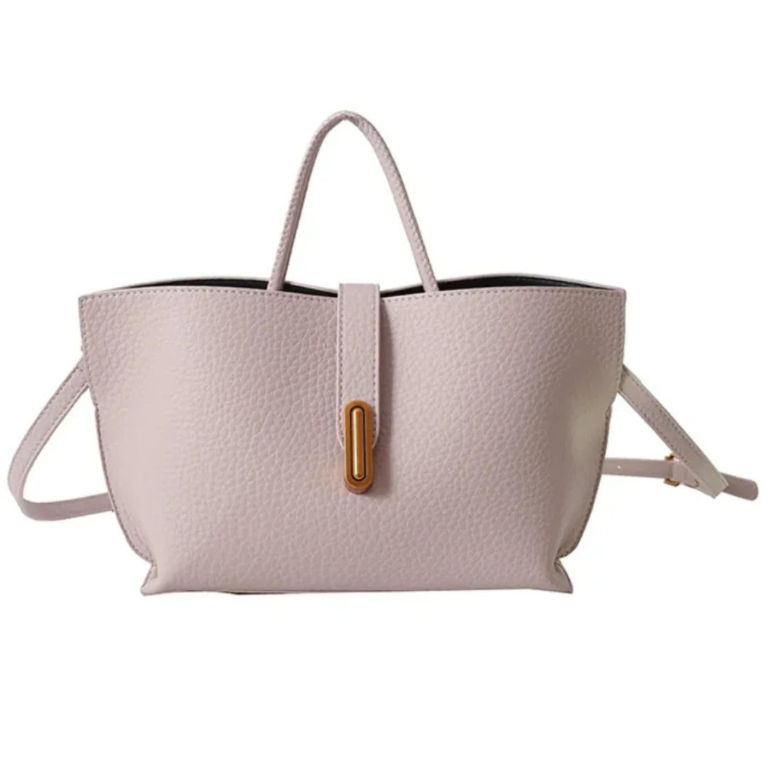 Light pink leather tote bag with gold accent, top handle, and crossbody strap
