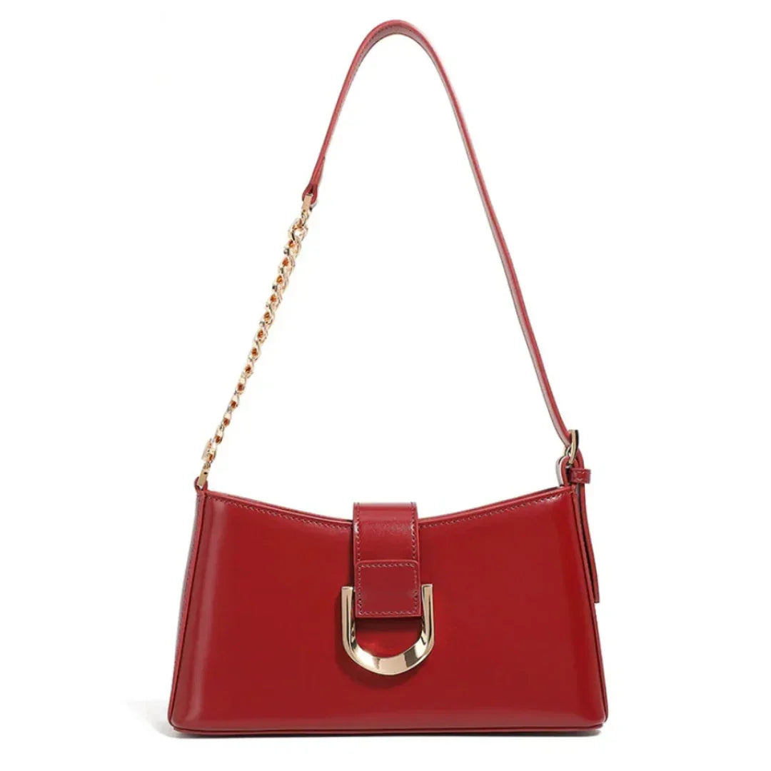 Red leather shoulder bag with gold chain strap and metallic buckle front detail