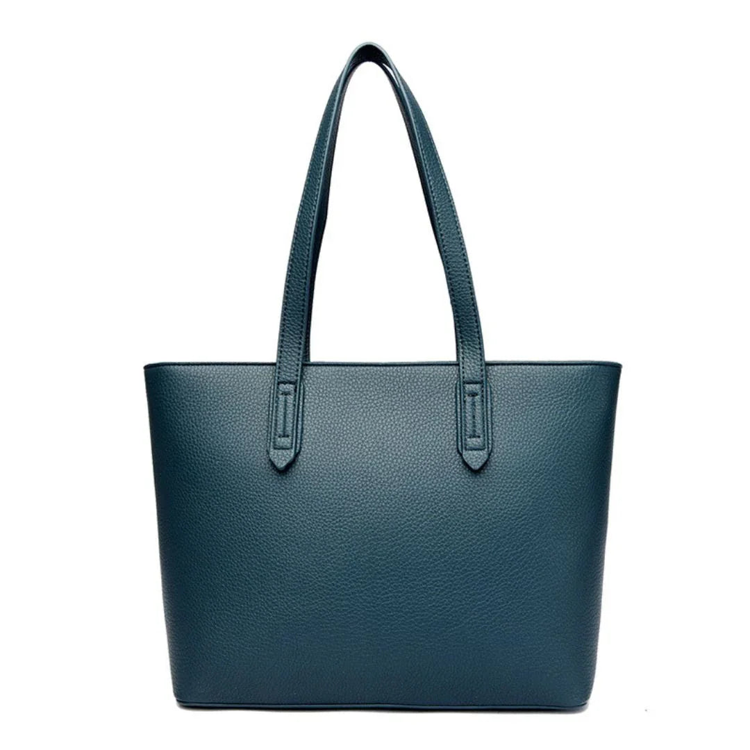 Teal leather tote bag with double handles on white background