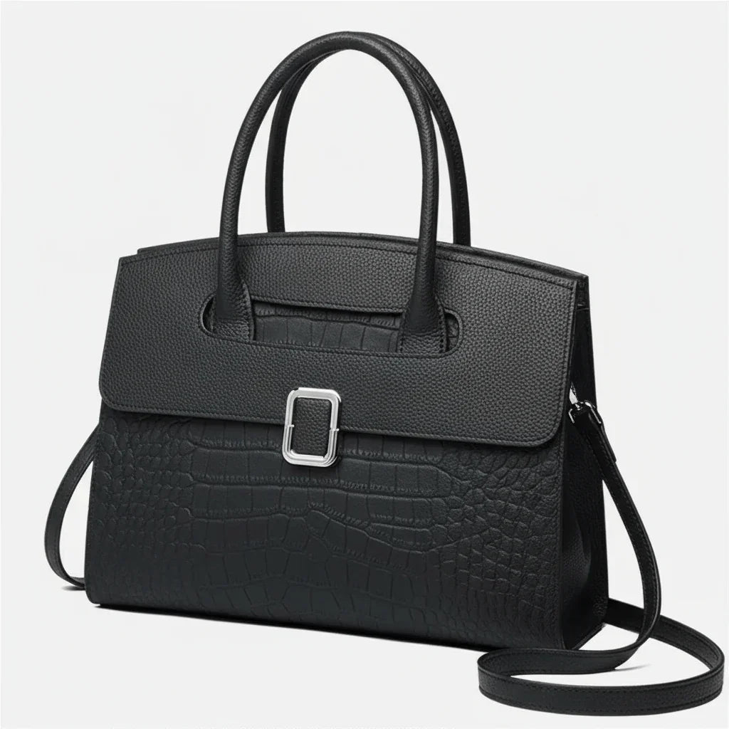 Elegant black leather handbag with crocodile texture and silver buckle on white background