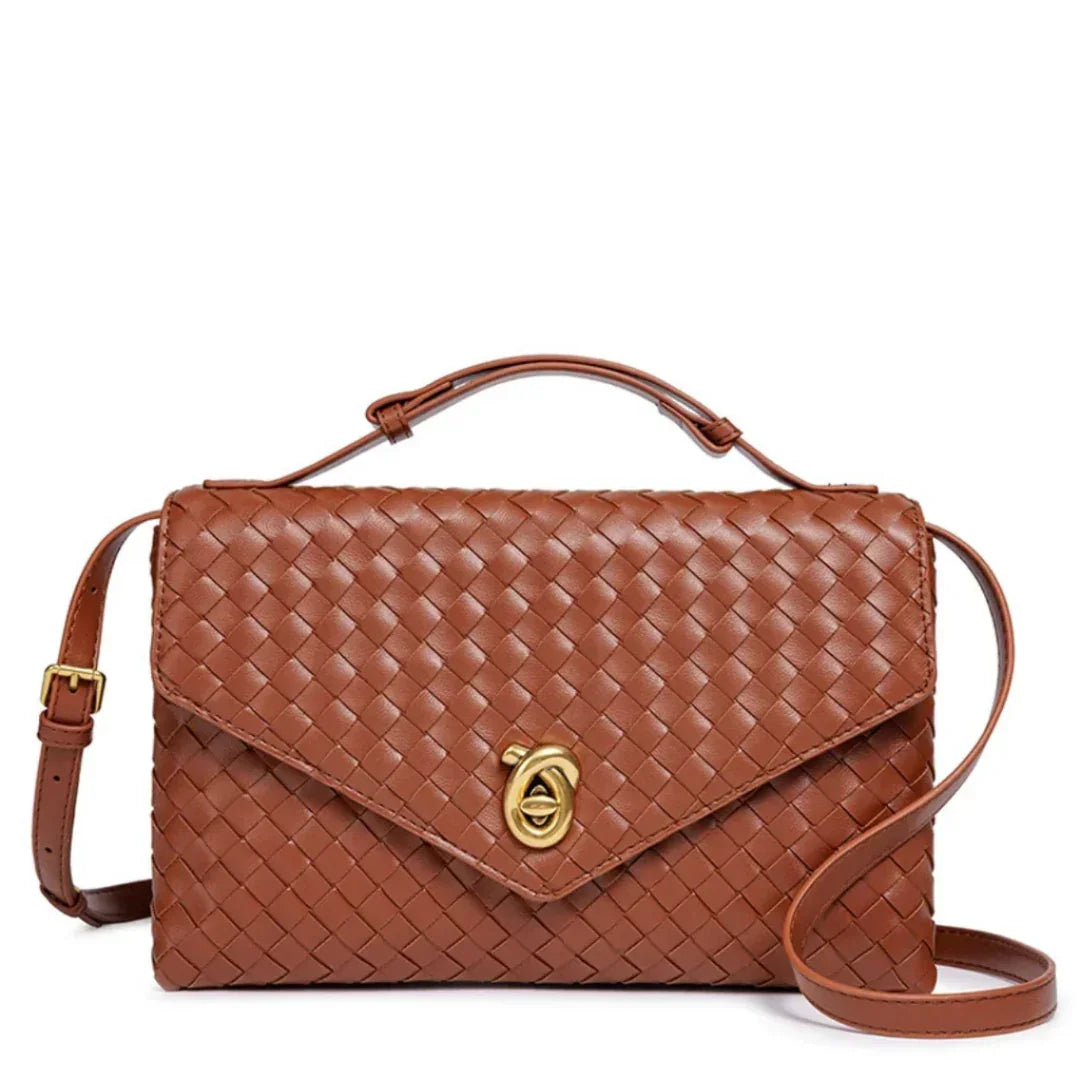 Brown woven leather crossbody bag with gold clasp and adjustable strap on white background