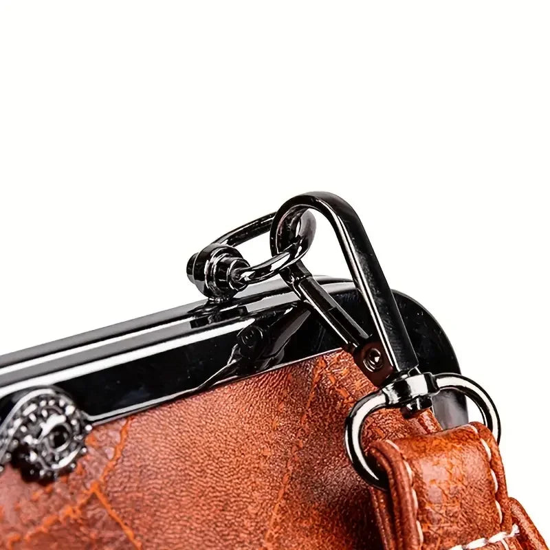 Close-up of brown leather bag strap with metal swivel clasp and silver hardware
