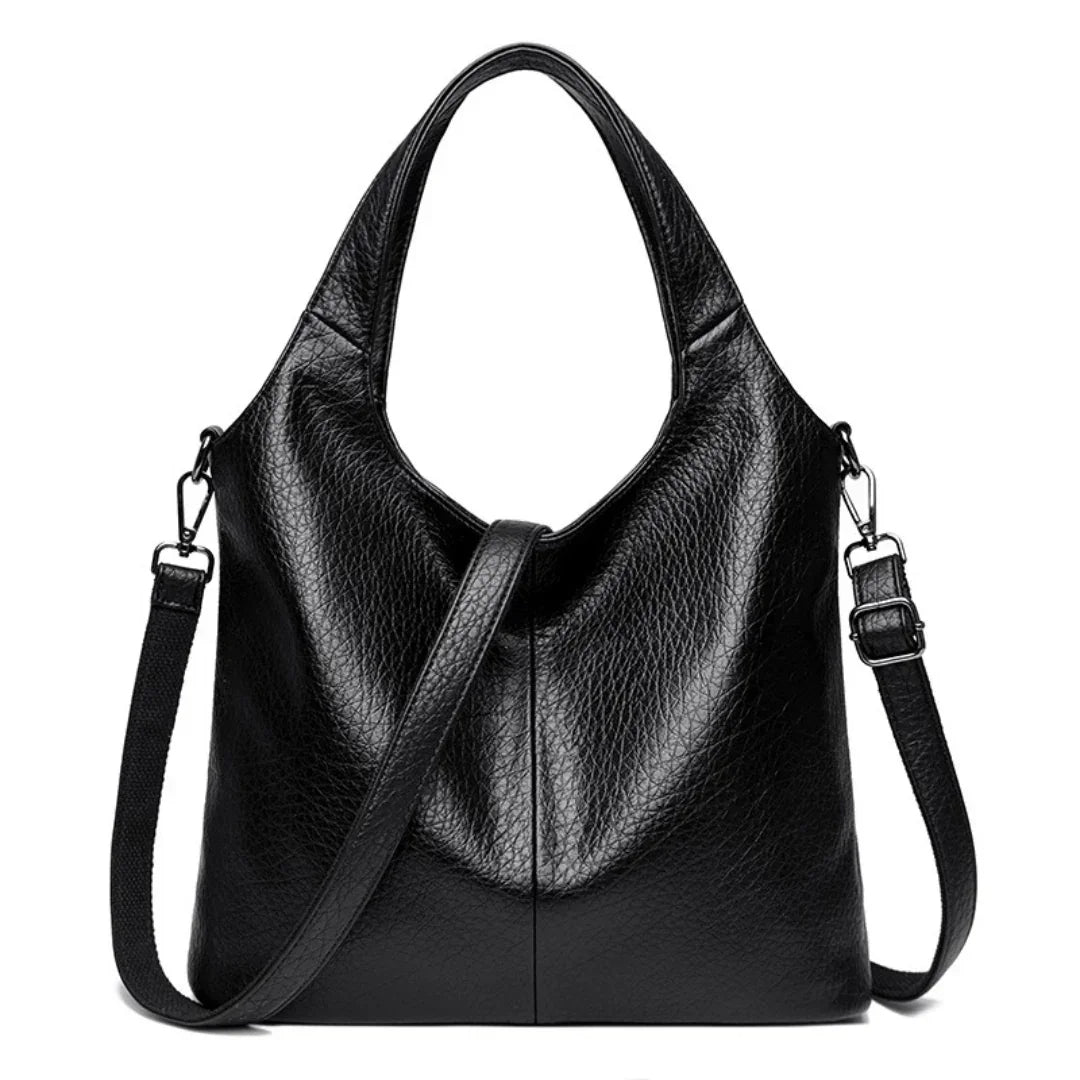 Black leather tote bag with adjustable shoulder strap and textured finish