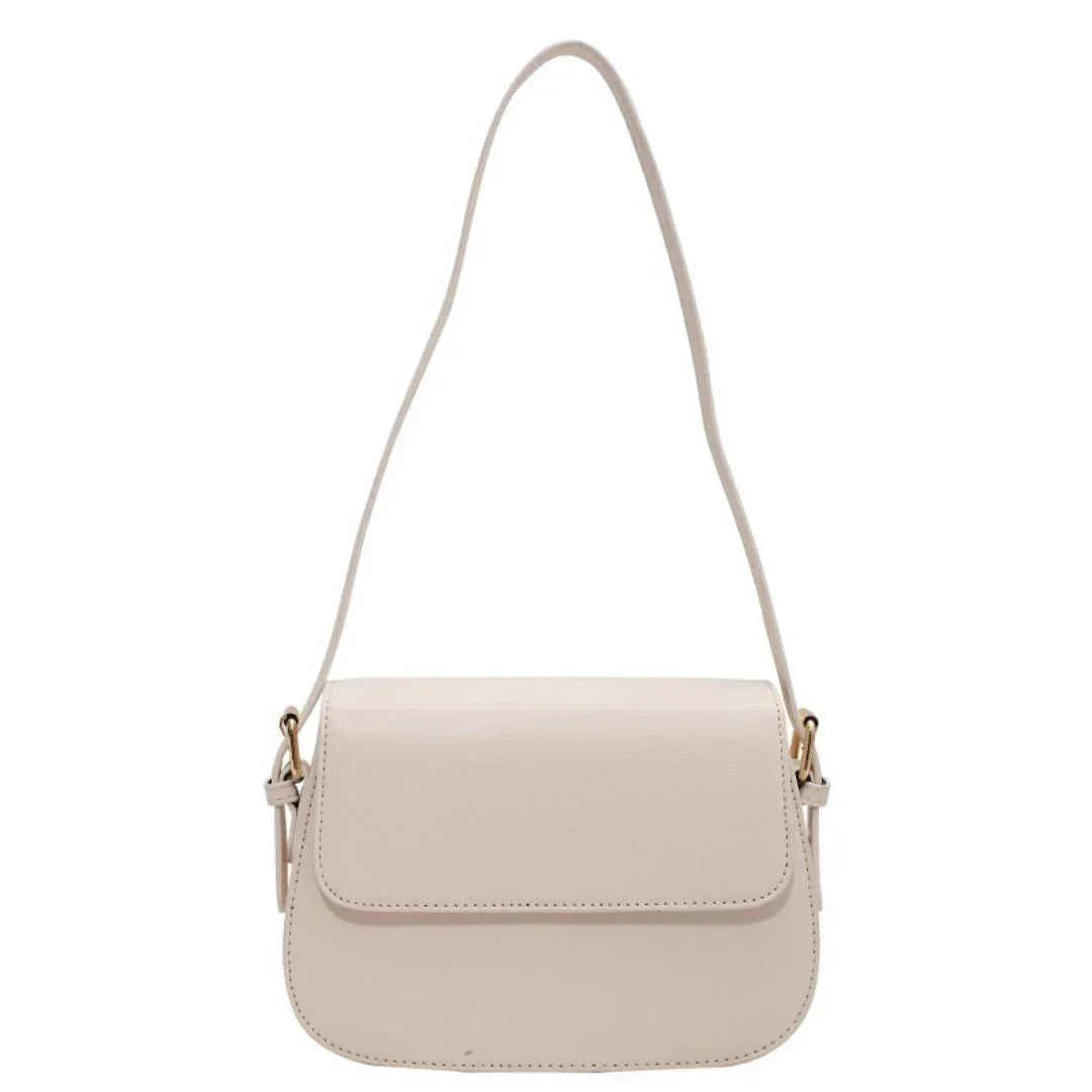 Beige leather shoulder bag with flap closure and gold-tone hardware on a white background