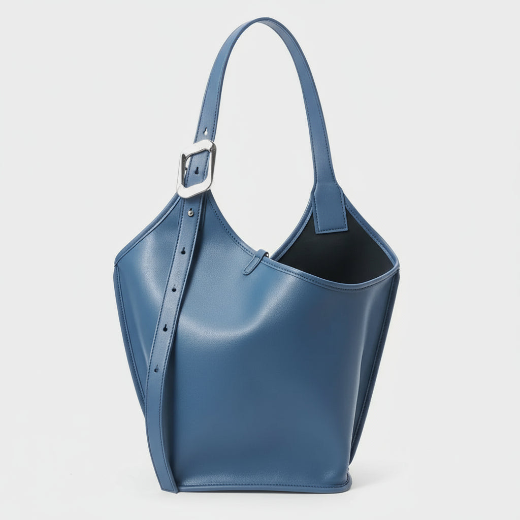 Blue leather bucket bag with silver buckle strap on white background