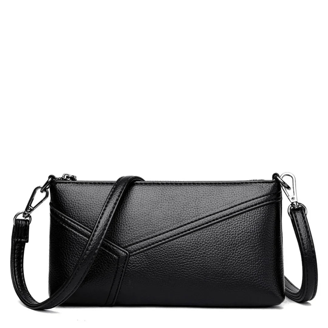 Black leather crossbody bag with detachable strap and geometric stitching details