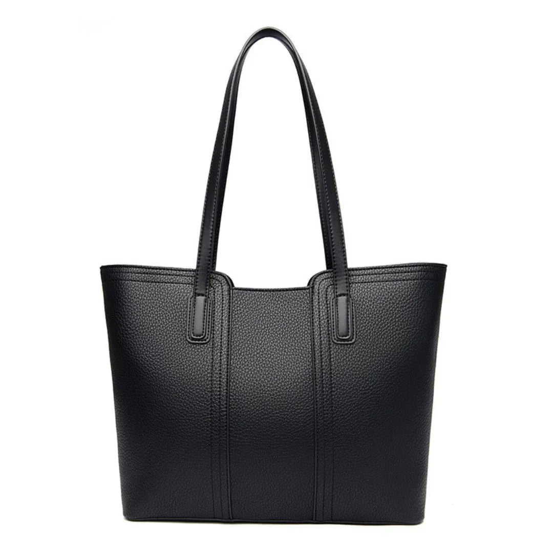 Black leather tote bag with double handles on white background