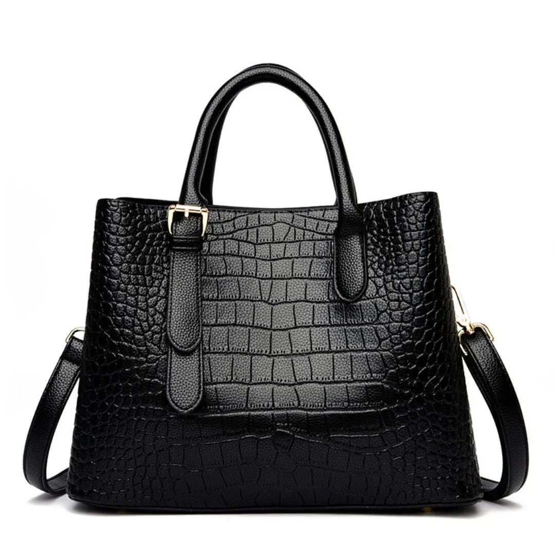 Black crocodile-embossed leather handbag with gold hardware and detachable strap