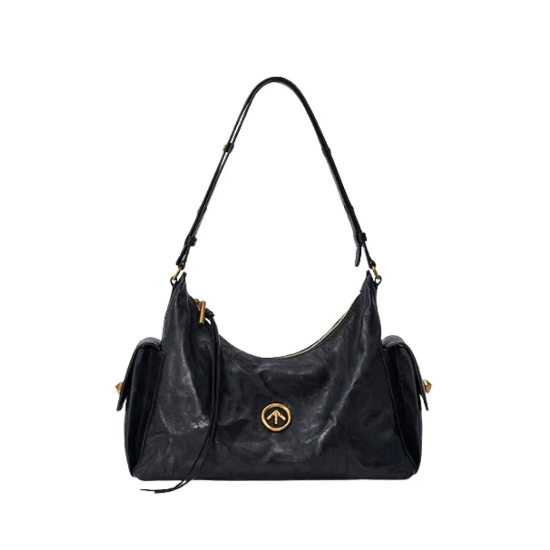 Black leather shoulder bag with gold zipper and round logo on white background