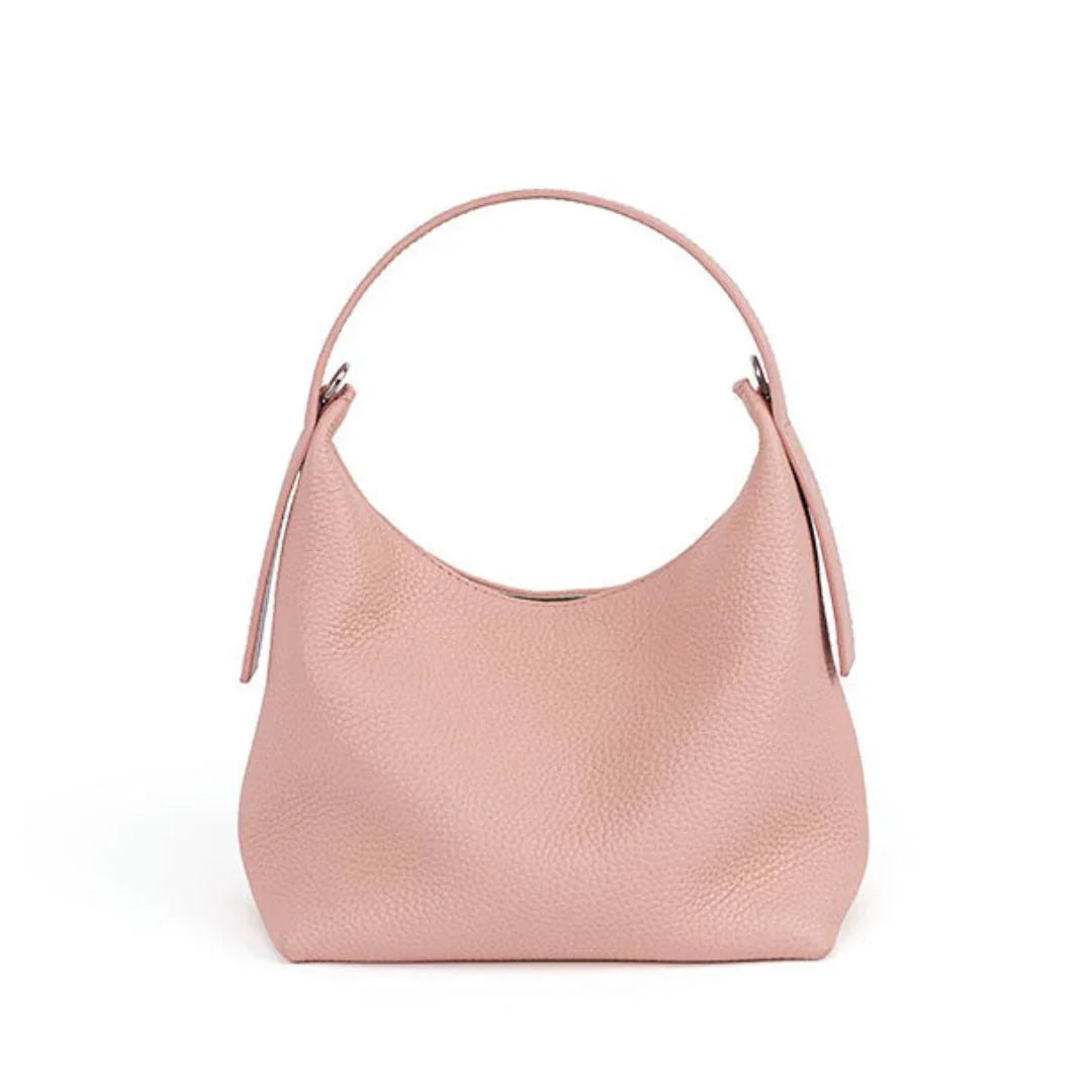 Light pink leather hobo handbag with single strap on white background