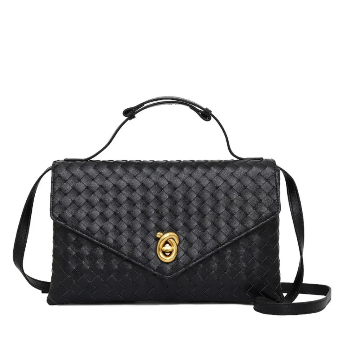 Black woven leather crossbody bag with gold clasp and top handle, on white background