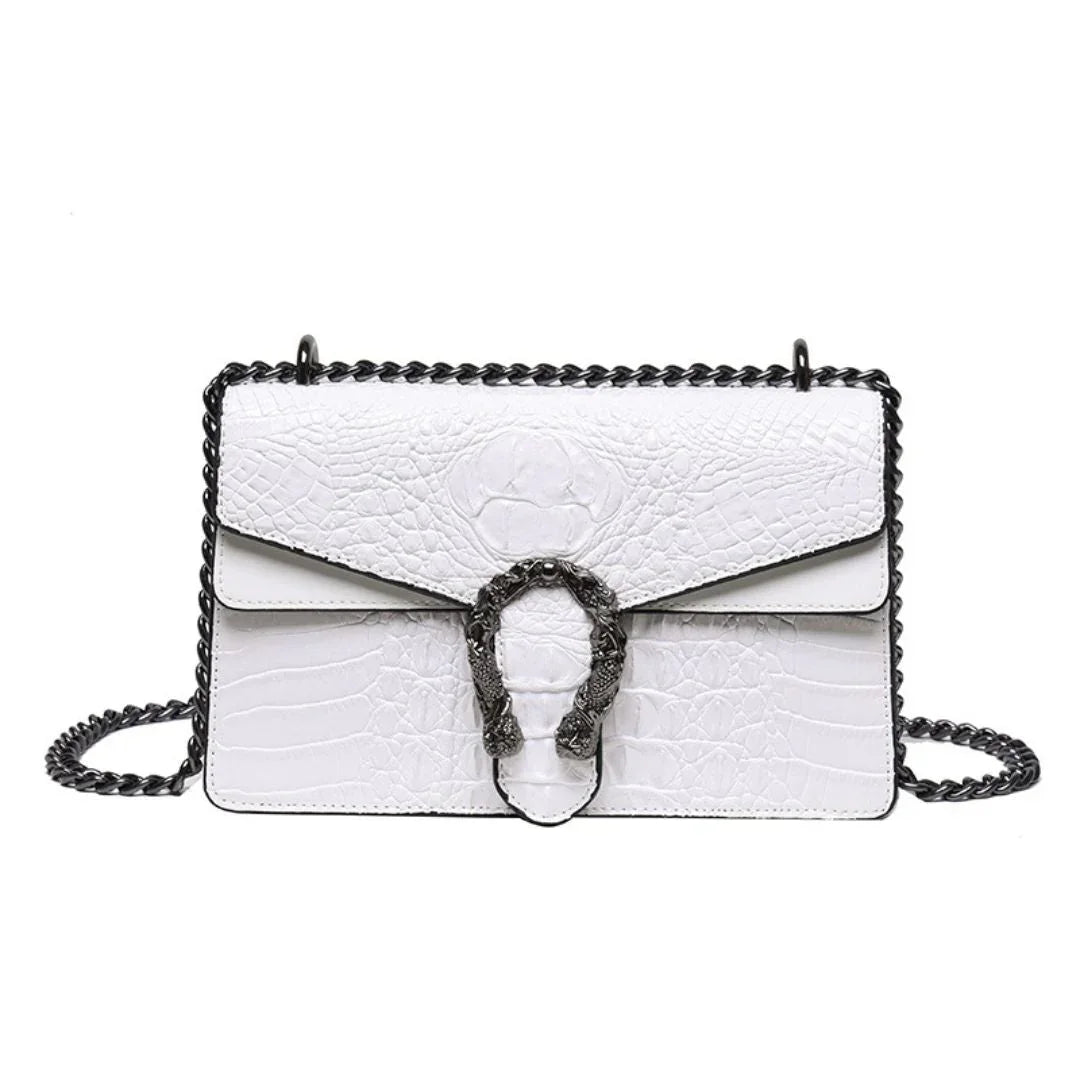 White crocodile-embossed leather shoulder bag with black chain strap and decorative metal clasp