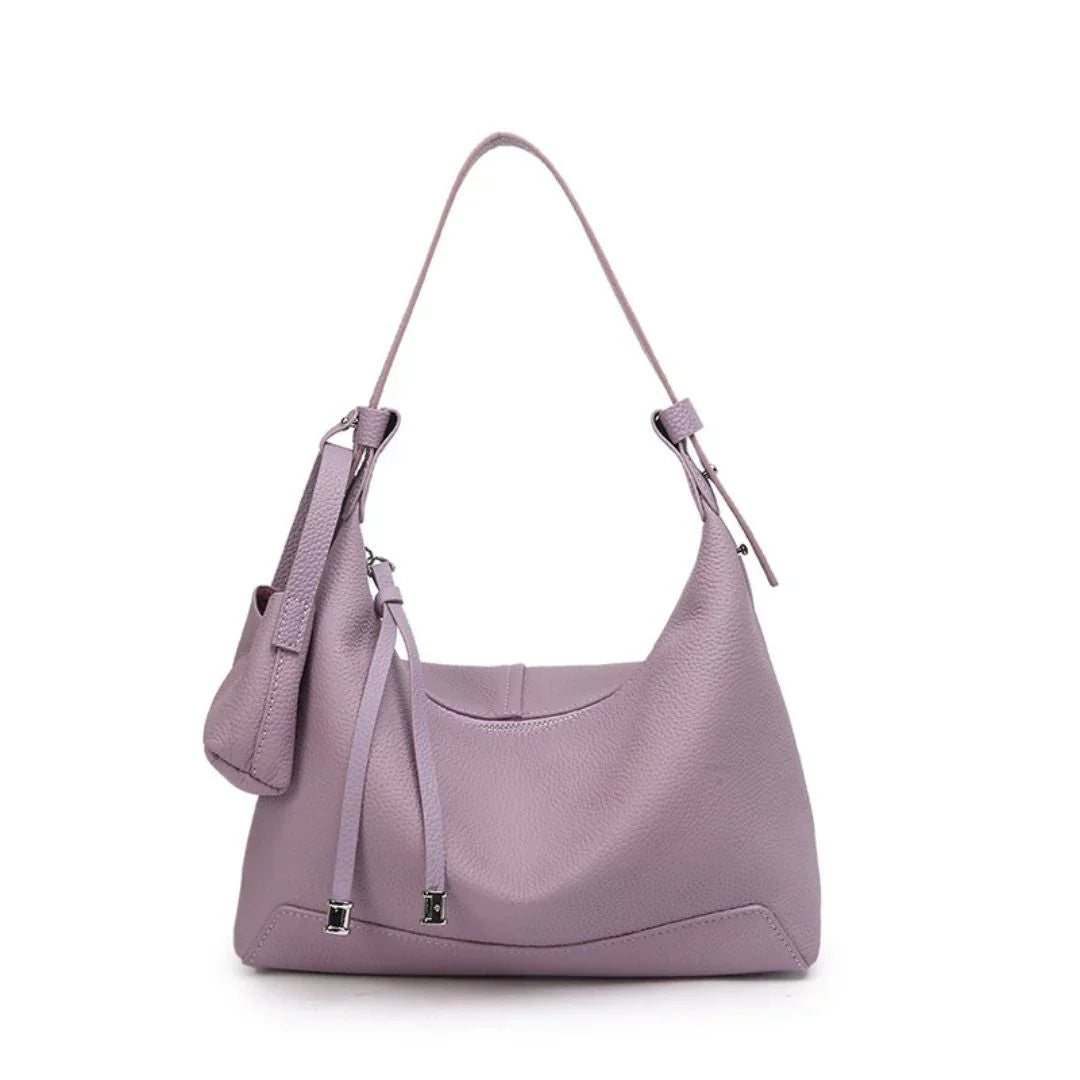 Lavender leather hobo bag with shoulder strap and matching pouch on white background