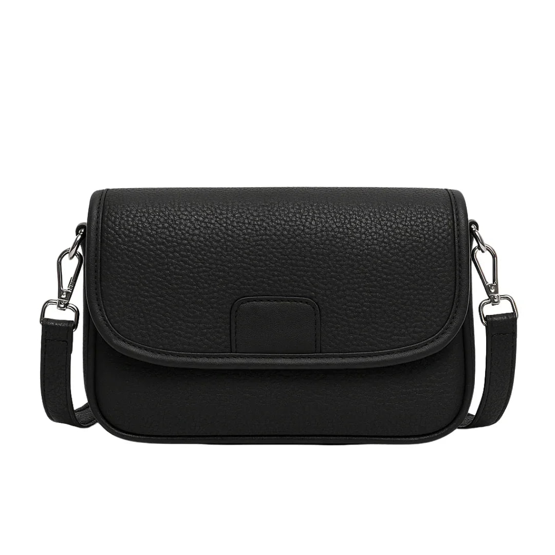 Black textured leather crossbody bag with flap closure and silver hardware on white background