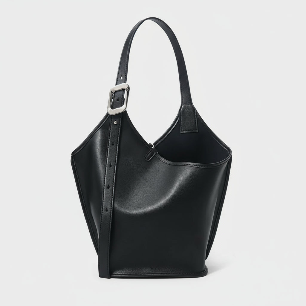 Black leather bucket bag with adjustable strap and silver buckle on white background