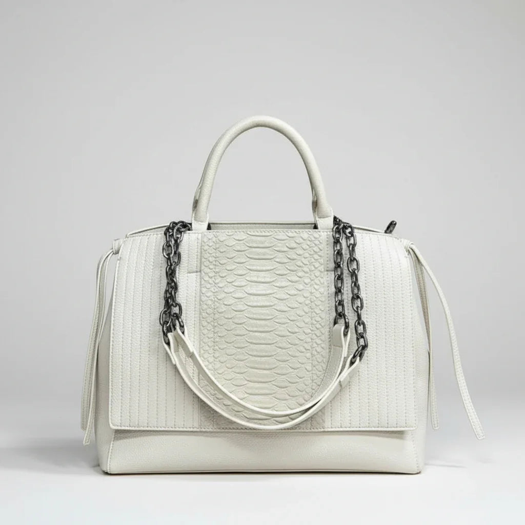 White leather handbag with textured snakeskin pattern and black chain detail