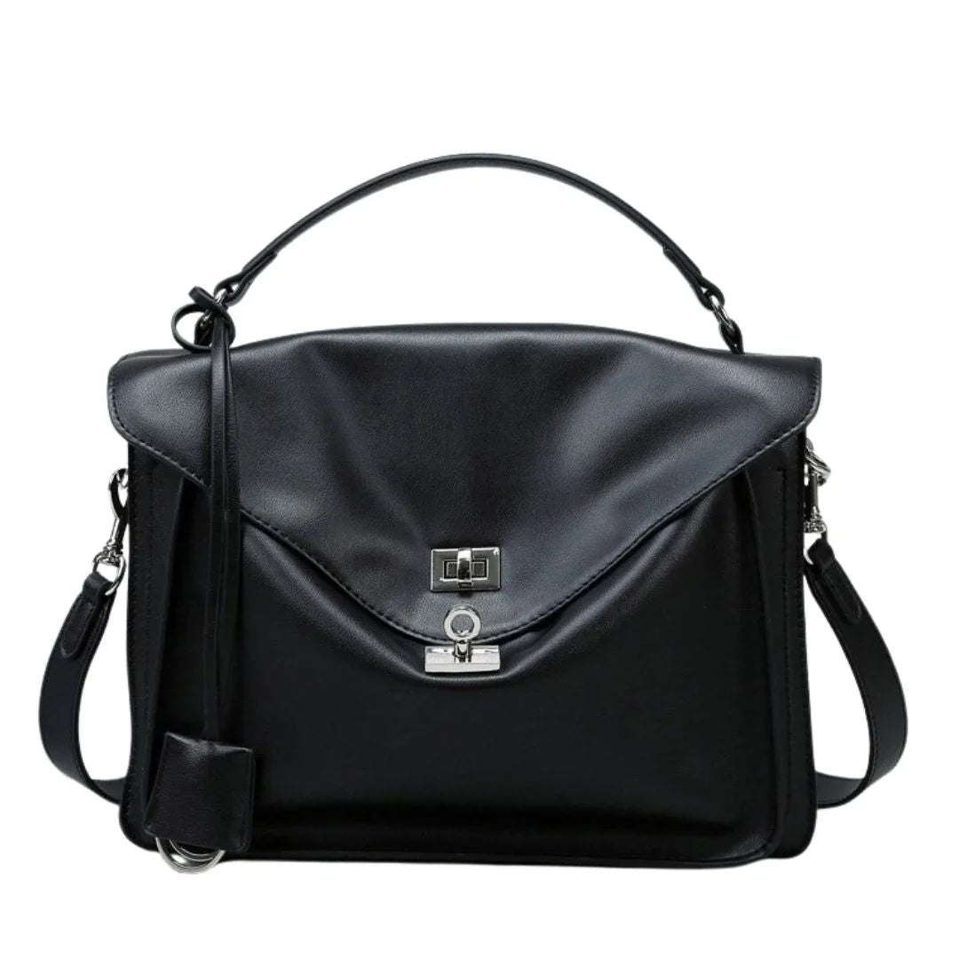 Black leather satchel handbag with top handle and silver clasp on white background