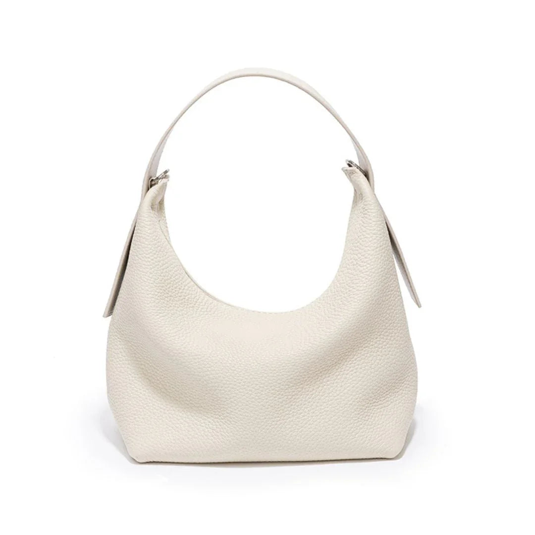 White leather hobo bag with textured finish and top handle on white background