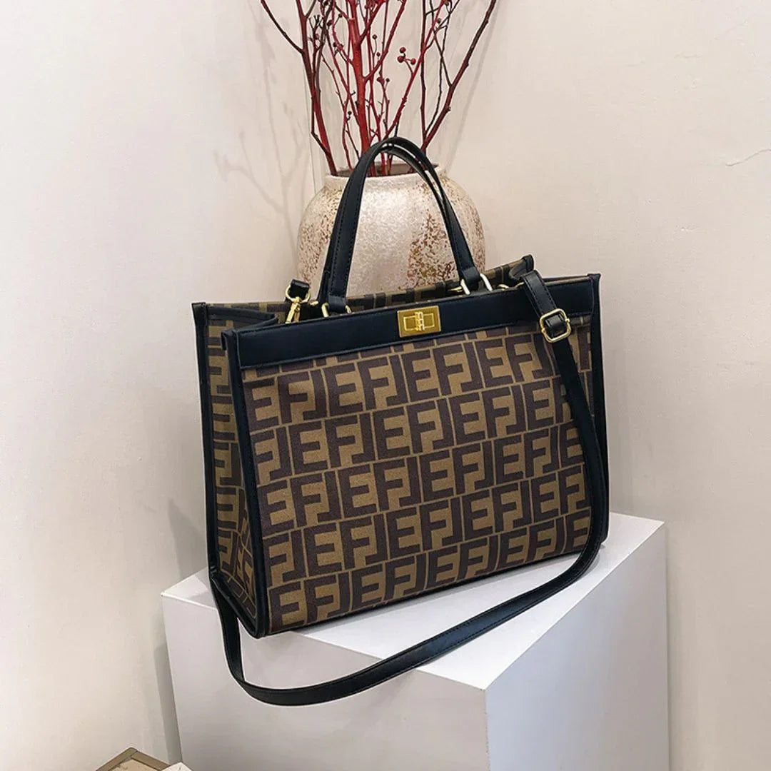 Brown designer tote bag with black FF logo pattern and gold hardware on display