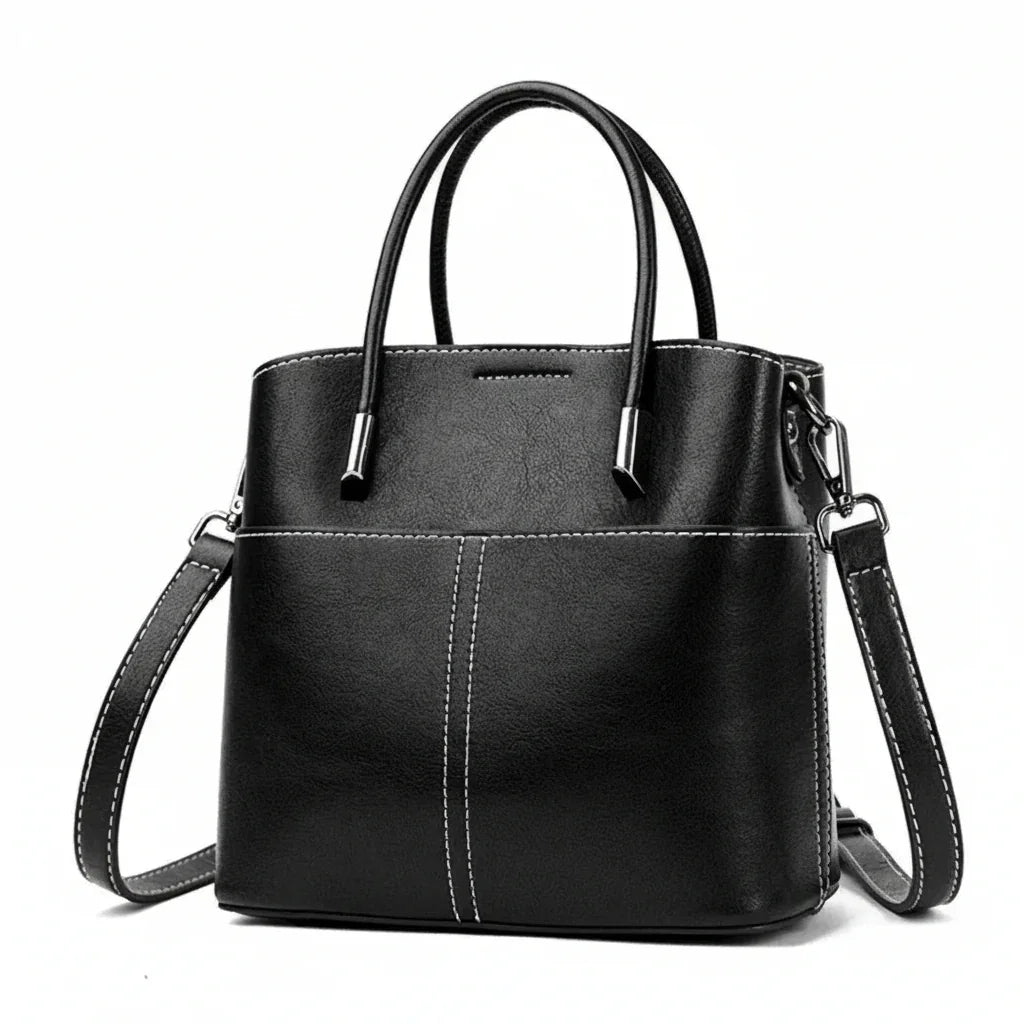 Black leather handbag with white stitching, top handles, and a detachable shoulder strap