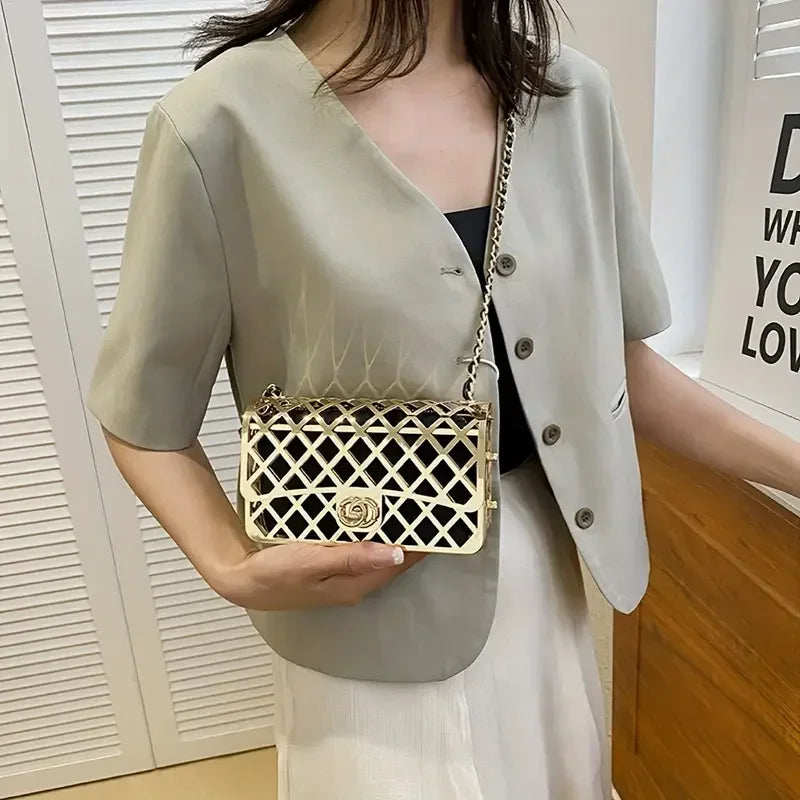 Woman wearing beige short-sleeve blazer with gold lattice crossbody bag