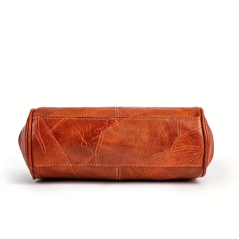 Brown leather bag base with visible stitching and textured leaf pattern, isolated on white