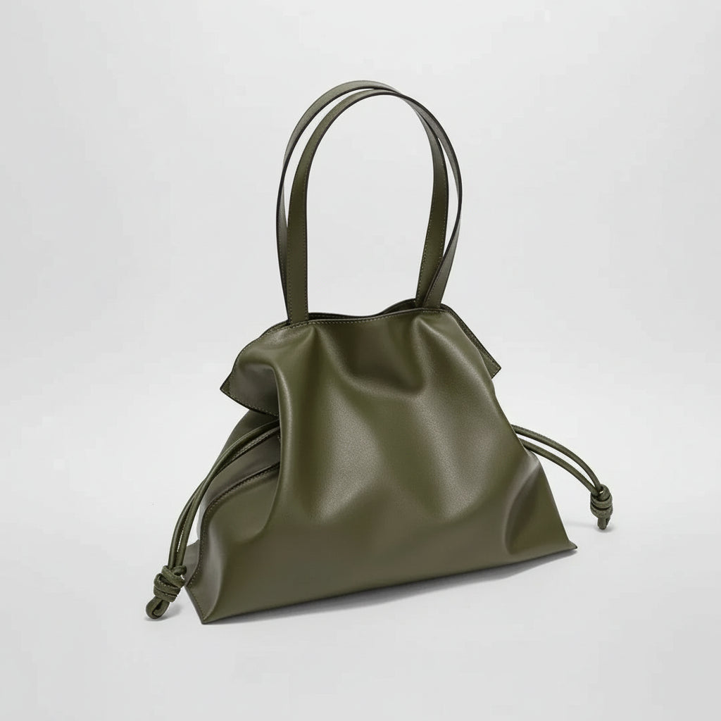 Olive green faux leather tote bag with double handles and side knot accents on a plain background