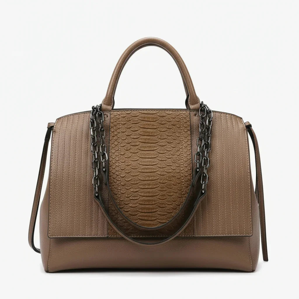 Brown textured leather handbag with chain strap and top handles against white background