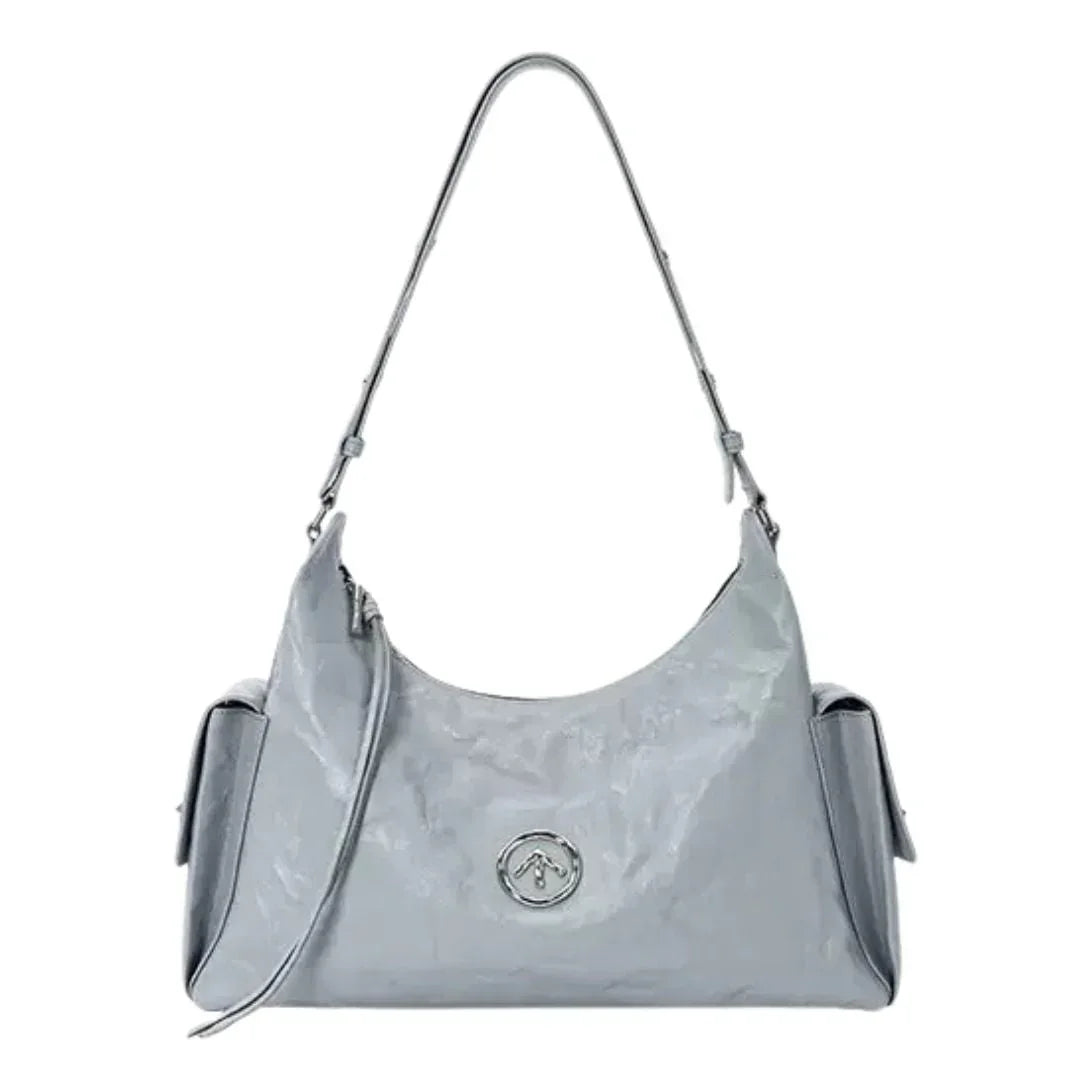 Glossy light gray shoulder bag with silver logo, side pockets, and detachable strap