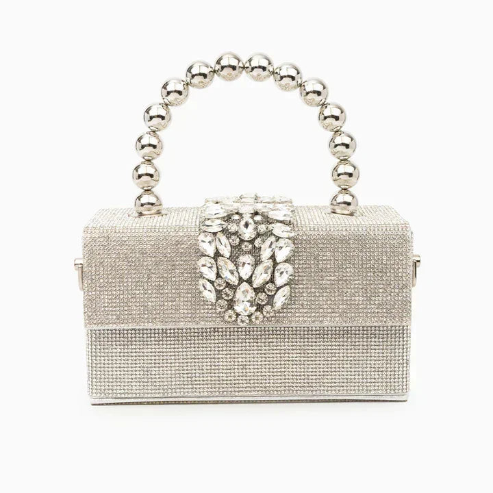 Silver crystal box clutch with jeweled clasp and metallic beaded handle on white background
