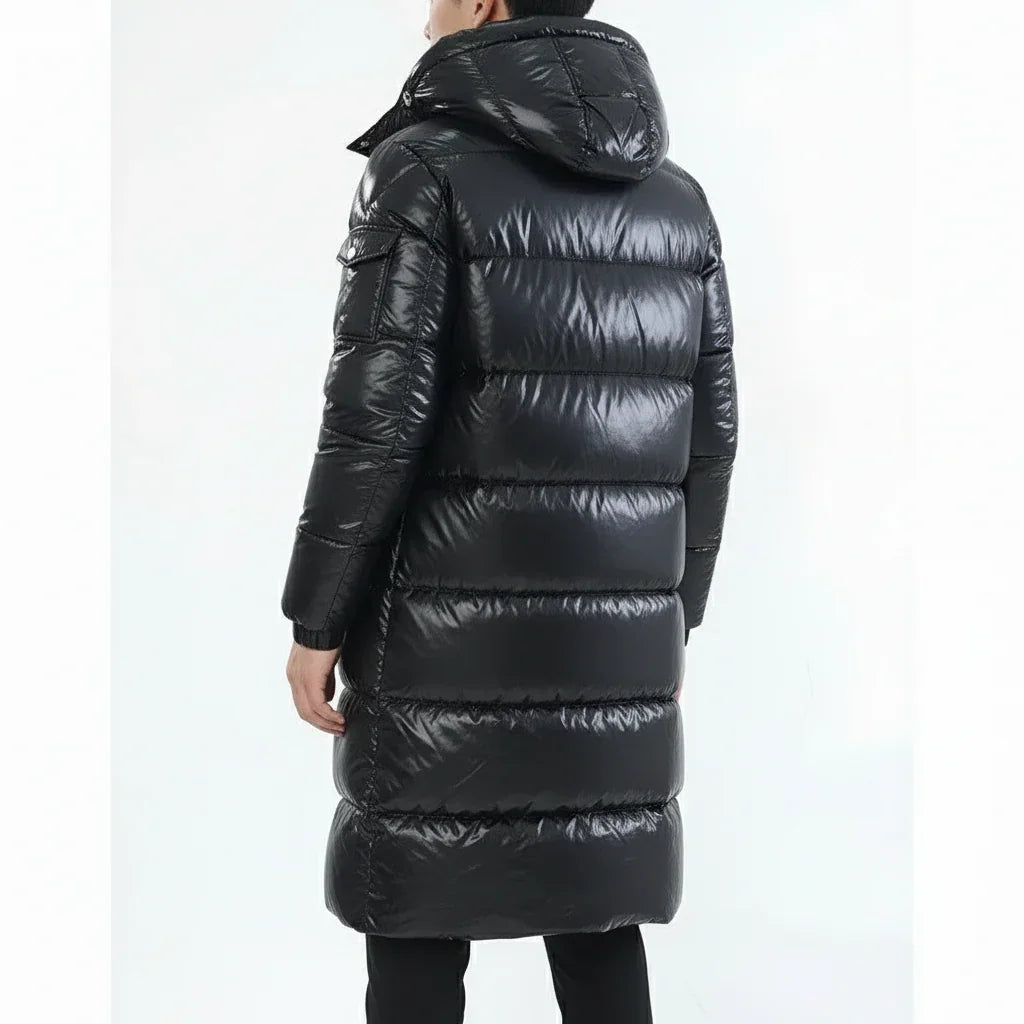 Person wearing a black puffer coat on a white background