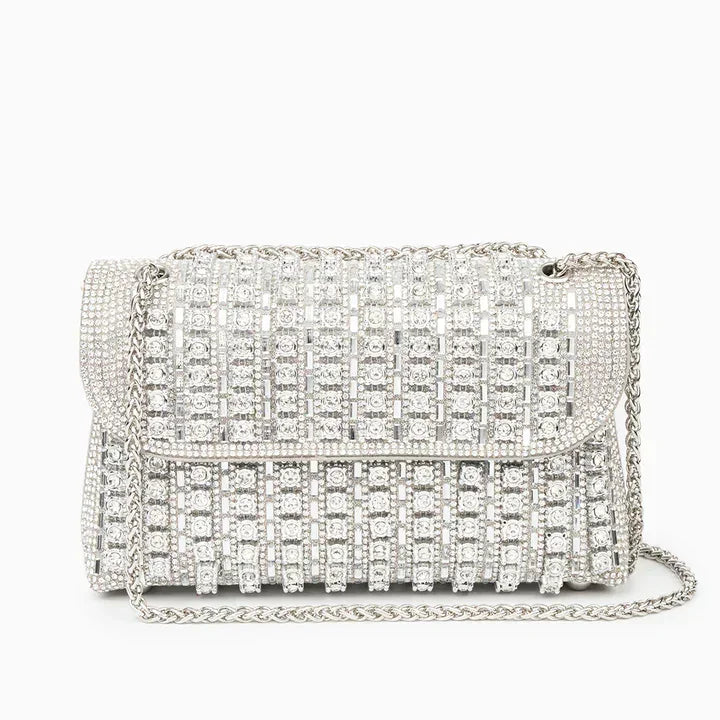 Silver rhinestone evening bag with chain strap and geometric crystal design on white background