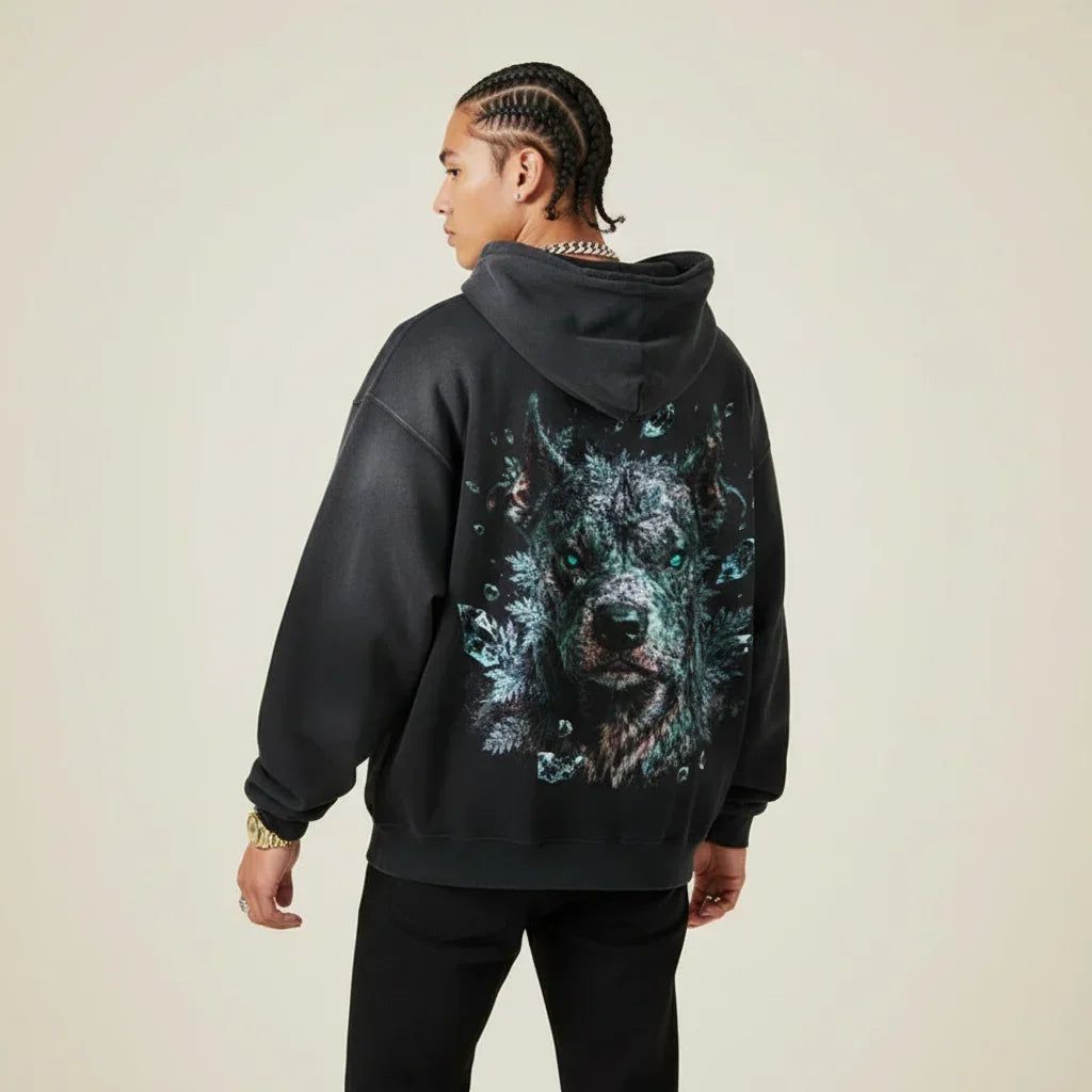 Person wearing a black hoodie with a Pitbull graphic on the back against a plain background