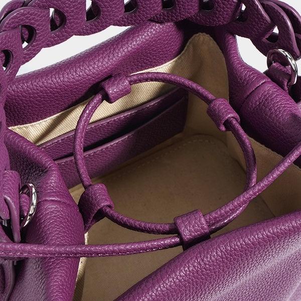 Interior view of purple leather bucket bag with beige lining and inner pocket