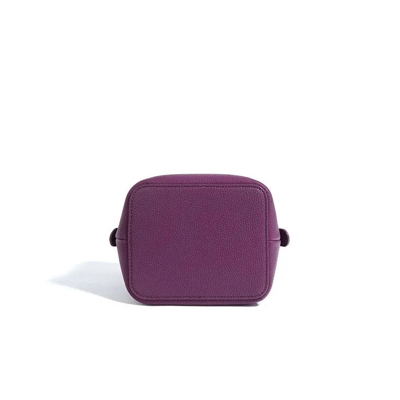 Purple leather crossbody bag with square shape on white background