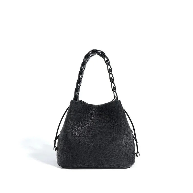 Black leather tote bag with chain handle on white background
